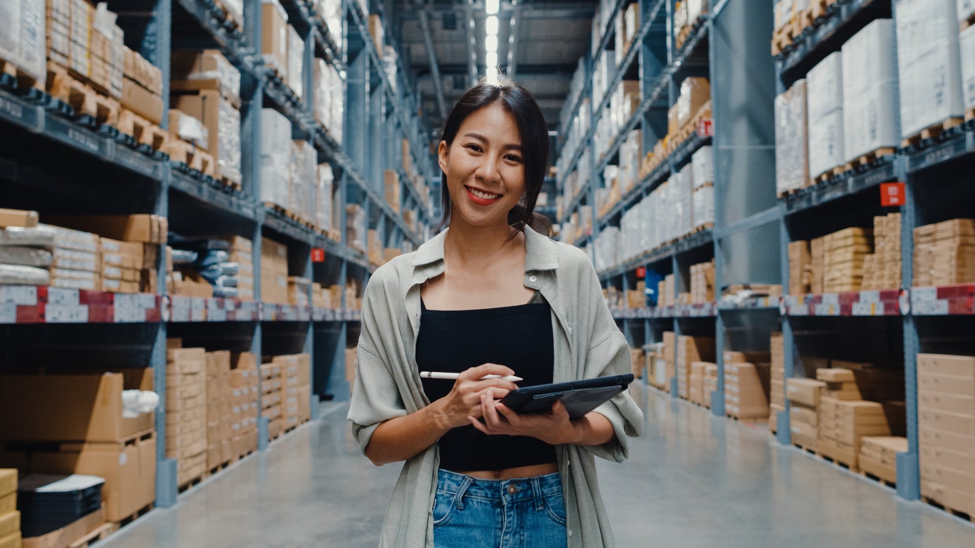 Business owner checking stock in a warehouse, funded with a working capital loan